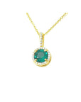 A round cut natural emerald encircled in a halo diamond pendant in yellow gold.