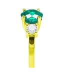This round cut natural emerald ring with side diamonds made in 18k yellow gold is displaying its top and side profile.