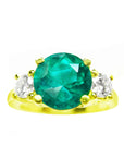 Natural round cut emerald with two side diamonds ring yellow gold, close top view on a top front position