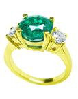 A 18k yellow gold emerald ring on lateral position top and gallery profile view.