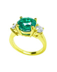 2.44 ct. GIA certified F1 Colombian emerald three-stone ring with round diamonds in 18K yellow gold.