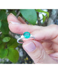 1.10 ct round Colombian emerald ring with baguette side diamonds in 14K white gold.