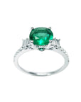 1.10 ct. round Colombian emerald ring with baguette side diamonds on a 14K white gold band.