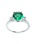 1.10 ct. round Colombian emerald ring with baguette side diamonds on a 14K white gold band.