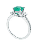 A 14k white gold emerald engagement ring on a half side displaying top gallery and shank profile.