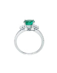 1.10 ct. round Colombian emerald ring with baguette side diamonds in 14K white gold.