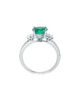 1.10 ct. round Colombian emerald ring with baguette side diamonds in 14K white gold.