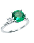 Natural round cut emerald and accent baguette diamonds ring top side profile.