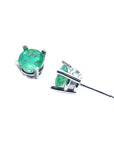 Pair of round-cut Colombian emerald stud earrings in 14k white gold.