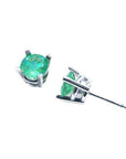 Pair of round-cut Colombian emerald stud earrings in 14k white gold.