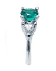 An emerald and side trillion cut diamonds ring, on a top and side down profile position.