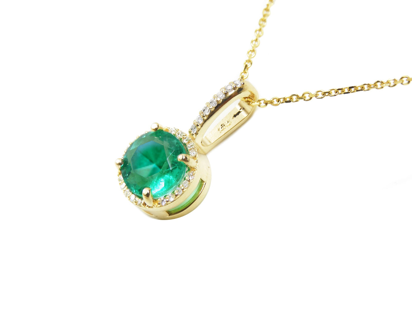 A 14k yellow gold round emerald pendant necklace displaying the top and gallery profile side.