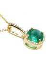 A yellow gold round cut natural colombian emerald halo diamond d
showing the top and gallery right profile side.