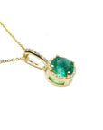 1.80 ct. round natural emerald pendant necklace with halo diamonds in 14K yellow gold.