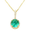Gold necklace with a round cut emerald pendant on a topside position view.