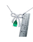 18K white gold bow-tie necklace with a pear-shaped deep green emerald.