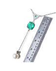 1.91 carat emerald cushion cut necklace with hanging pearl, 14K white gold, shown with ruler.