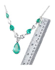 14k white gold necklace with pear-shaped emeralds and diamonds, shown with a ruler for scale.