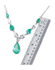 14k white gold necklace with pear-shaped emeralds and diamonds, shown with a ruler for scale.