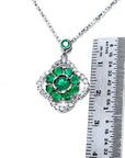 14K white gold cluster necklace with natural Colombian emeralds in a clover design, surrounded by diamonds.