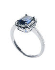 14K white gold solitaire ring with an emerald cut blue sapphire, rope frame, and accent diamonds.