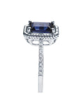 1.03 ct. emerald cut blue sapphire solitaire ring in 14K white gold with rope frame and diamond accents.