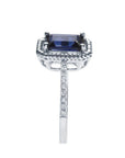 1.03 ct. emerald cut blue sapphire solitaire ring in 14K white gold with rope frame and diamond accents.