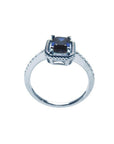 1.03 ct. emerald cut blue sapphire solitaire ring in 14K white gold with rope frame and accent diamonds.