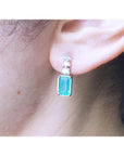 14K white gold earring with rectangular emerald and three round diamonds.