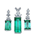 Set of natural emerald gemstone earrings with diamond tops on a front position top view