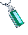 Right side top view of an emerald gemstone pendant pending of a white gold chain