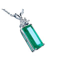 Emerald pendant with a rectangular medium bluish-green emerald and diamond accents in 14K white gold.