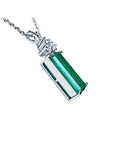 14K white gold pendant with a rectangular medium bluish-green emerald and accent diamonds.