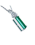 14K white gold pendant with a rectangular medium bluish-green emerald and accent diamonds.