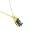 14k gold necklace with a rectangular emerald-cut blue sapphire pendant and three accent diamonds.