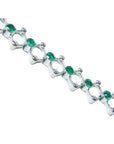 14K white gold bracelet with round Colombian emeralds bezel set in diamond-shaped links.