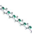 14K white gold bracelet with round Colombian emeralds bezel set in diamond-shaped links.