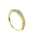 14K yellow gold bangle bracelet with round Colombian emeralds and diamonds in a floral design.