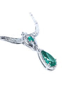 14K white gold necklace with a pear-shaped emerald pendant surrounded by diamonds.