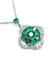 Close view of a natural emeralds necklace cluster set within a delicate 4-leaf clover design, crafted in 14k white gold
