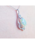 Opal pendant necklace on a pink skin background.