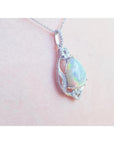 Pear-shaped rainbow Welo Ethiopian Opal pendant in 925 sterling silver with cubic zirconia accents.