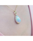 Opal pendant necklace on a soft pink skin background