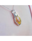 Ethiopian opal pendant with vibrant play of colors and brown pinpoint fire, set in a silver wire wrap.