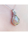 Opal pendant silver necklace on a person's neck with a white background.