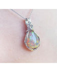 Welo Ethiopian multicolor opal pendant with a pear-shaped stone in a handmade silver wire wrap setting.