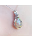 Welo Ethiopian multicolor opal pendant with a pear-shaped stone in a handmade silver wire wrap setting.