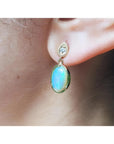 Solid Australian opal earrings with bluish-green play of color, dangling diamond studs, 14K yellow gold.