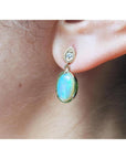 Solid Australian opal earrings with bluish-green play of color, dangling diamond studs, 14K yellow gold.