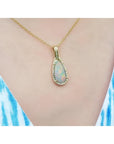 4.30 ct. solid Australian opal teardrop pendant with halo diamonds on an 18K yellow gold chain.